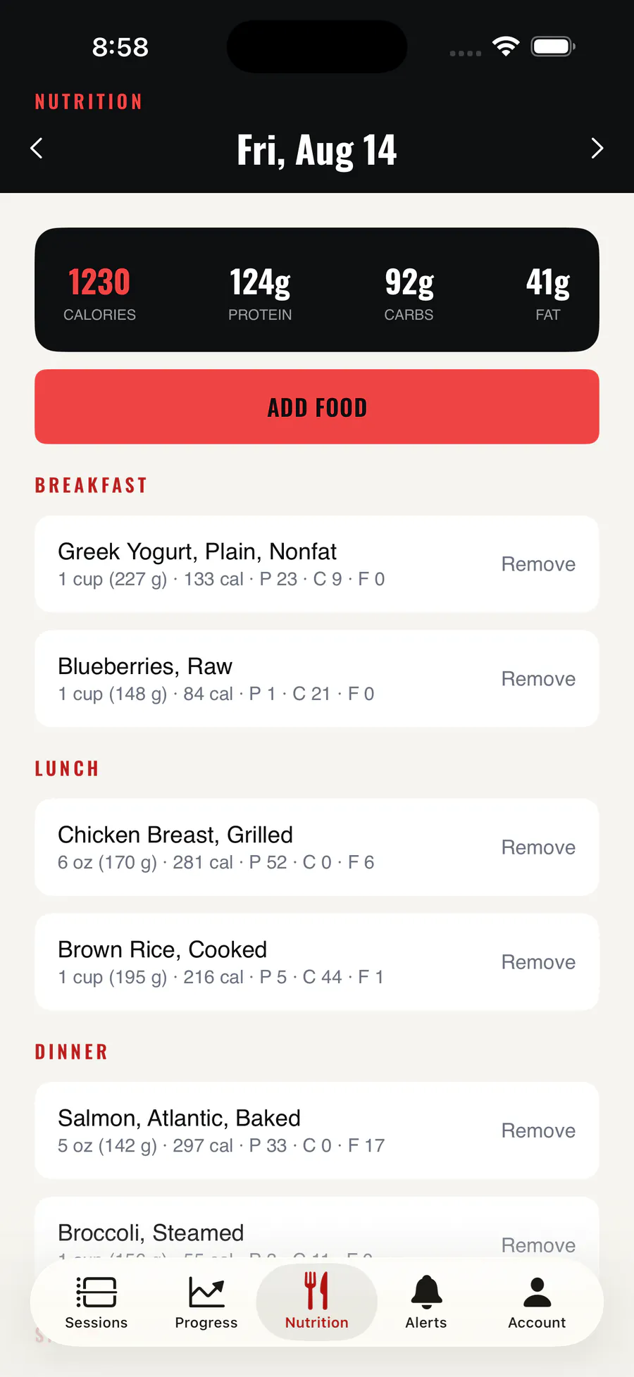 The MFTC app nutrition log for a single day, showing calorie and macro totals above the meals logged for breakfast, lunch and dinner.