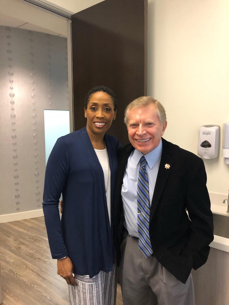 Coach Peters with a member of the Cunning Dental Group team.