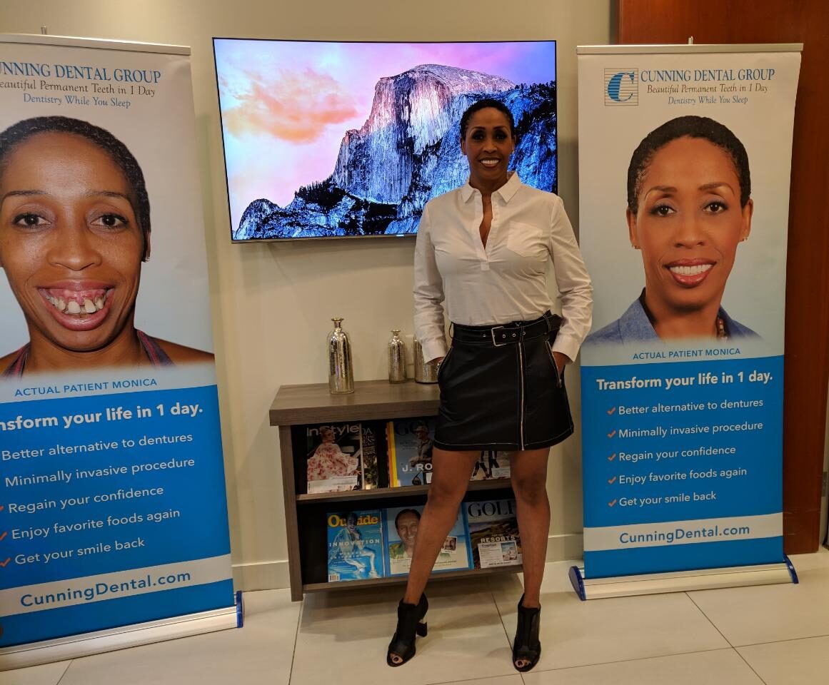 Coach Peters beside her Cunning Dental Group before-and-after banners.