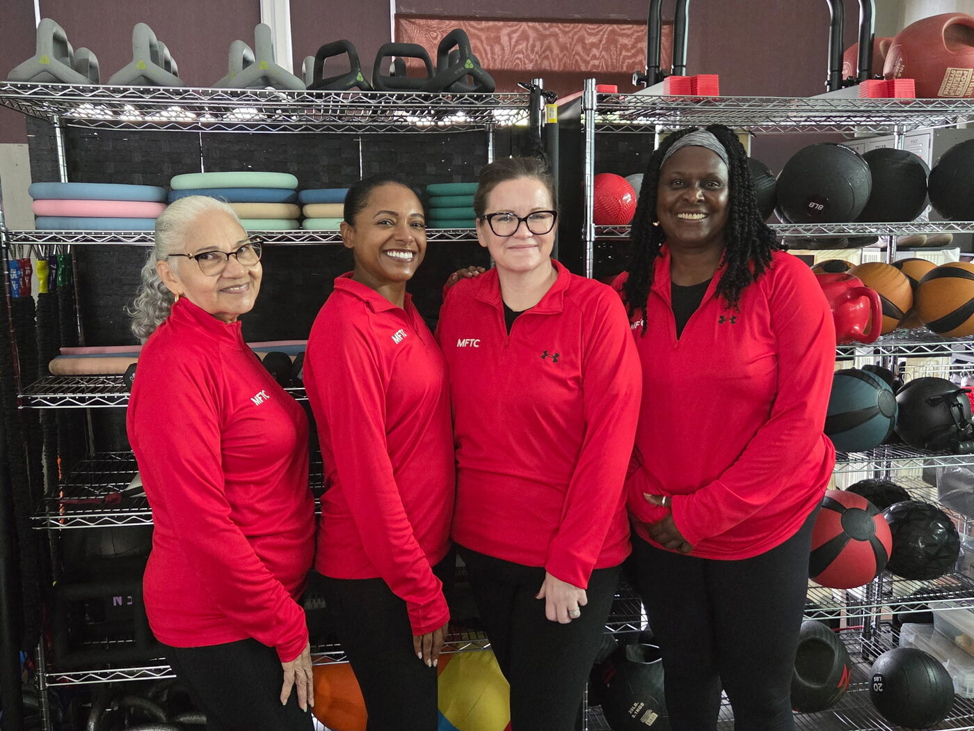 The Marathon Fitness Training Center coaching team together on the facility floor.